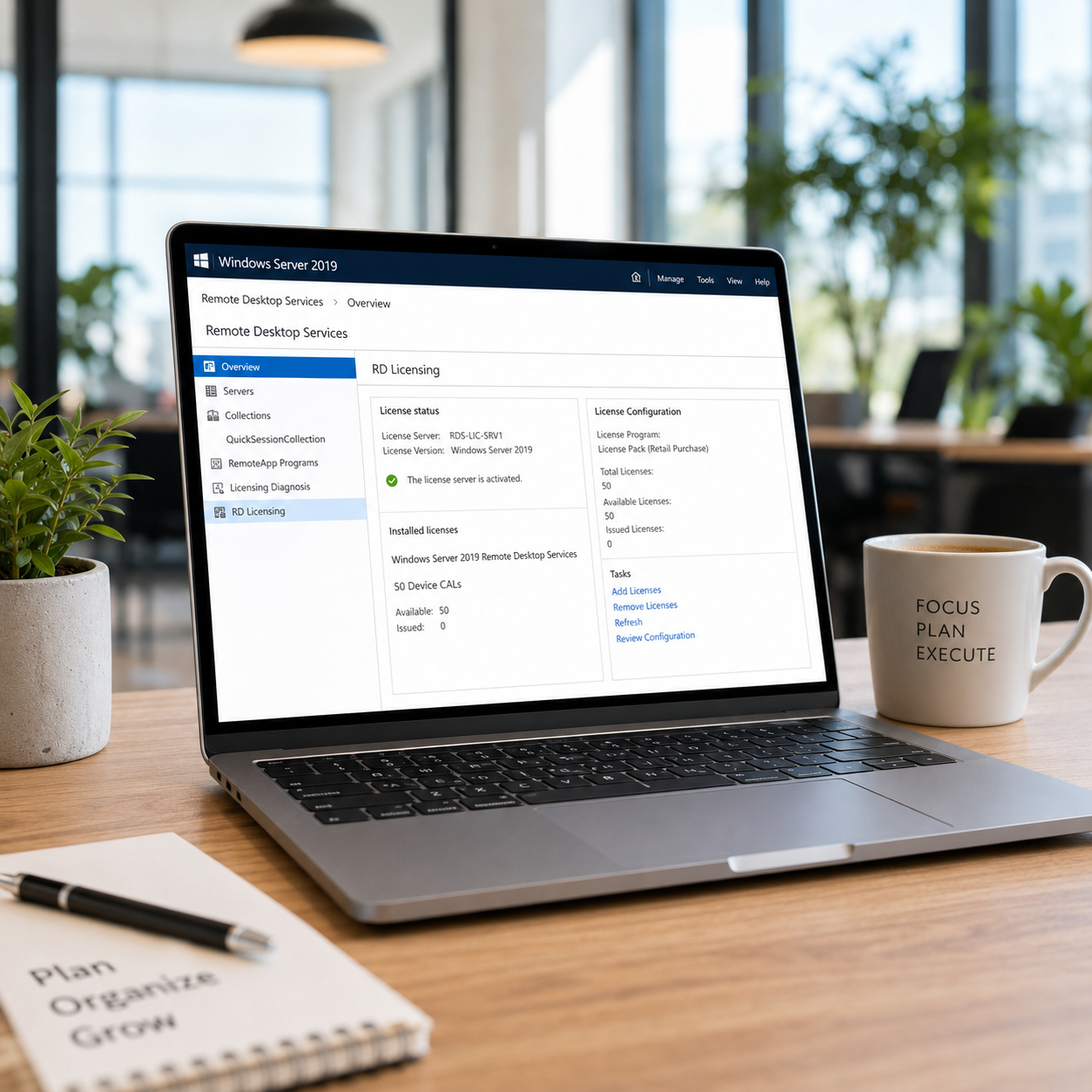 Laptop on a desk with a Windows Server 2019 RDS 50 Device CAL interface, coffee mug, and notebook in an office setting.